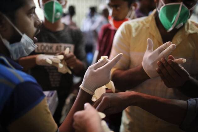 March 24, 2020, Dhaka, Bangladesh: People buy hand gloves as a preventive measure against the spread of the COVID-19 coronavirus from a street vendor at the capital. Dhaka Bangladesh - ZUMAh143 20200324_zap_h143_007 Copyright: xMDxMehedixHasanx