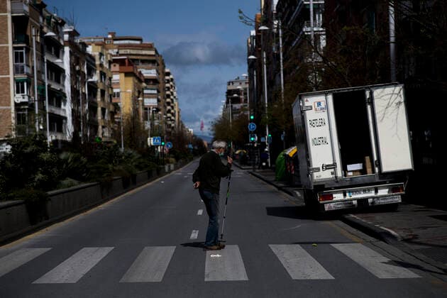 March 24, 2020, Granada, Spain: An elderly man crossing the street while wearing a face mask as a preventive measure, during the covid-19 pandemic..After 11 days of the state of emergency in Spain due to the coronavirus outbreak, there are more than 29,900 infected and 2,700 deaths. Granada Spain - ZUMAs197 20200324_zaa_s197_040 Copyright: xCarlosxGilx