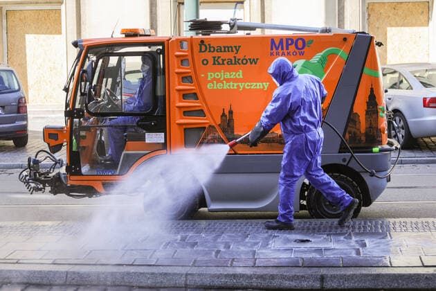 March 24, 2020, Cracow, Lesser Poland, Poland: Worker wearing a protective suit as a preventive measure while doing the disinfection during the corona pandemic..Municipal cleaning services spray disinfectants in public places, including public transport stops as a preventive measure against the coronavirus pandemic. Cracow Poland - ZUMAs197 20200324_zaa_s197_066 Copyright: xFilipxRadwanskix
