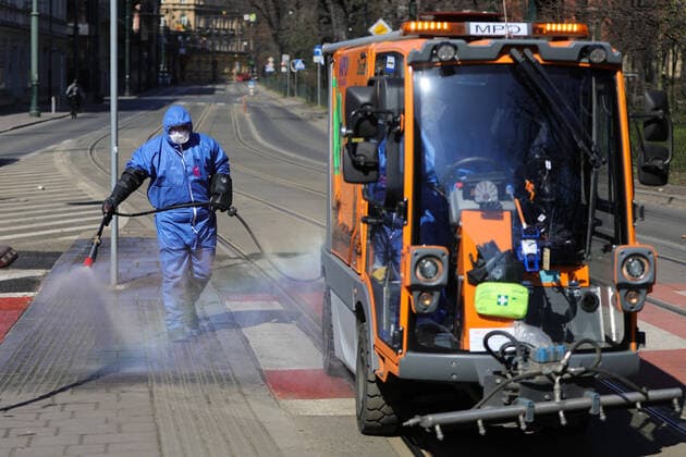 March 24, 2020, Cracow, Lesser Poland, Poland: Worker wearing a protective suit as a preventive measure while doing the disinfection during the corona pandemic..Municipal cleaning services spray disinfectants in public places, including public transport stops as a preventive measure against the coronavirus pandemic. Cracow Poland - ZUMAs197 20200324_zaa_s197_070 Copyright: xFilipxRadwanskix