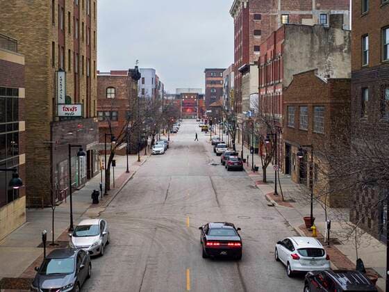 March 24, 2020, Des Moines, Iowa, U.S: A person crosses a street in an historic neighborhood in downtown Des Moines Tuesday. Many of the city residents chose to stay in Tuesday and the downtown area was deserted. On Tuesday morning, 24 March, Iowa reported over 120 confirmed cases of the Coronavirus (SARS-CoV-2) and COVID-19. Restaurants, bars, movie theaters, places that draw crowds are closed for at least 30 days. The Governor has not ordered shelter in place but several Mayors, including the Mayor of Des Moines, have asked residents to stay in their homes for all but the essential needs. People are being encouraged to practice social distancing and many businesses are requiring or encouraging employees to telecommute. Des Moines U.S. - ZUMAk94_ 20200324_zaf_k94_010 Copyright: xJackxKurtzx