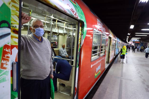 (200324) -- CAIRO, March 24, 2020 -- A passenger waits in the train as a man sprays disinfectant in a metro station in Cairo, Egypt, March 24, 2020. Egypt, a country with a population of 100 million people, has confirmed 366 COVID-19 cases, including 19 deaths. (Photo by Ahmed Gomaa Xinhua) EGYPT-CAIRO-METRO-COVID-19-MEASURES WuxHuiwo 