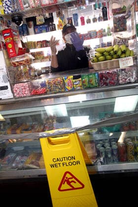 March 24, 2020, New York City, New York, US: Local bodega (mom and pop store) owner takes charge of his personal protection against the coronavirus (COVID-19) by erecting a self-made cautionary barrier, separating his customers and self against the rampaging pandemic in the South Bronx as seen on Tuesday, 25 March 2020. New York City US - ZUMAl135 20200324_zap_l135_004 Copyright: xG.xRonaldxLopezx