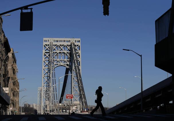 Pedestrian cross a Manhattan street near the George Washington Bridge in New York City on Tuesday, March 24, 2020. New York state reports the most coronavirus cases and deaths in the country with more than 23,230 confirmed cases and 188 deaths.  NYP20200324116 JOHNxANGELILLO