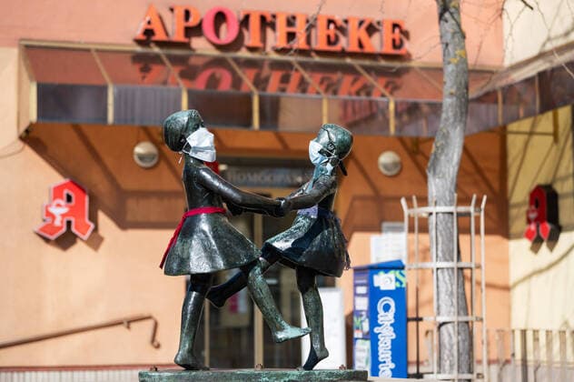 Unknown persons have attached breathing masks to the statue of two dancing girls in the center of Jena The statue is standing in front of a pharmacy Photo from 24 3 2020