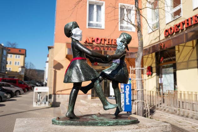 Unknown persons have attached breathing masks to the statue of two dancing girls in the center of Jena The statue is standing in front of a pharmacy Photo from 24 3 2020