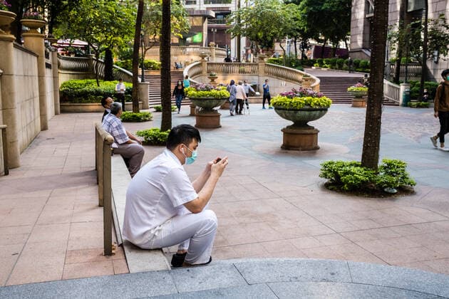 March 24, 2020, Hong Kong, China: A man on work break wearing a face mask as a preventive measure during the corona virus pandemic..As the coronavirus outbreak worsens, routine continues for businessmen and residents around the city, people wear face masks in fear of contracting the virus. Hong Kong China - ZUMAs197 20200324_zaa_s197_104 Copyright: xWilliexSiaux