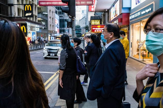 March 24, 2020, Hong Kong, China: A businessman wearing a face mask as a preventive measure during the corona virus pandemic..As the coronavirus outbreak worsens, routine continues for businessmen and residents around the city, people wear face masks in fear of contracting the virus. Hong Kong China - ZUMAs197 20200324_zaa_s197_111 Copyright: xWilliexSiaux