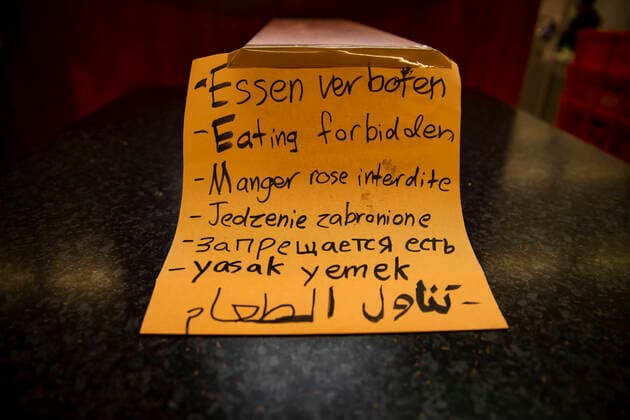 A sign Eating banned in many languages in a snack bar in Berlin on 24 March 2020 To slow down the spread of the coronavirus COVID 19, the federal and state governments decided to impose further restrictions After museums, theatres, sporting events etc. wer