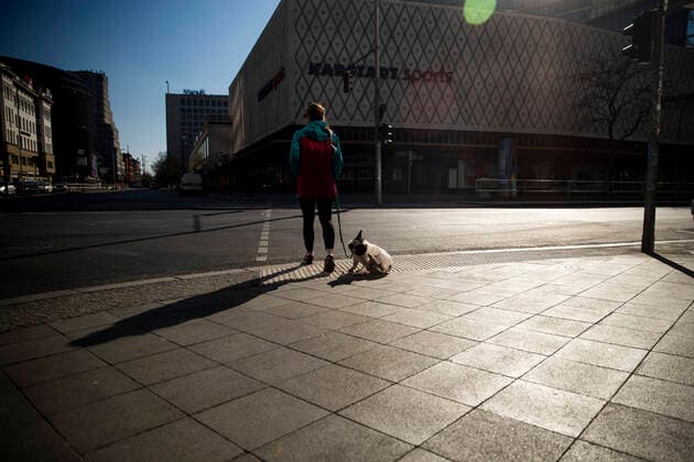 A young woman walks her dog in Berlin on 24 March 2020 To slow down the spread of the coronavirus COVID 19, the federal and state governments decided to impose further restrictions After museums, theatres, sporting events etc. were banned, as of yesterday, gatherings with more t