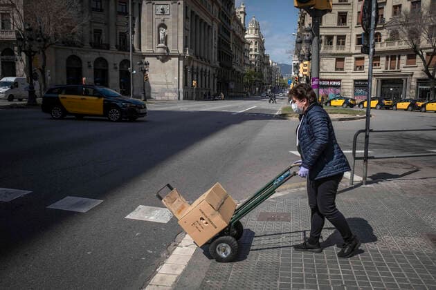 March 24, 2020, Barcelona, Catalonia, Spain: A food market worker is seen transporting a box of eggs with a wheelbarrow during the period of confinement..Barcelona faces its tenth day of confinement decreed by the Government of Spain due to the spread of the coronavirus. Barcelona Spain - ZUMAs197 20200324_zaa_s197_143 Copyright: xPacoxFreirex