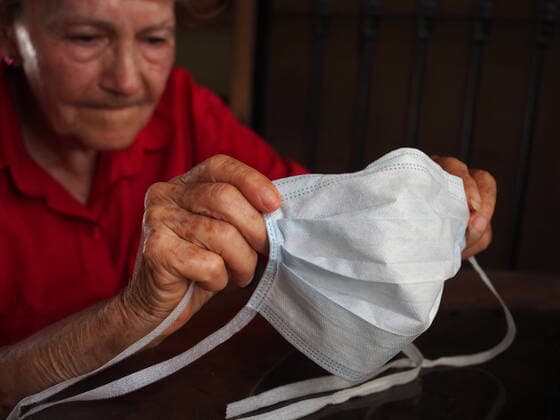 March 24, 2020, Lima, Lima, Peru: An elderly woman holding a mask, before putting it on, to protect herself from the coronavirus. Peru declared a state of emergency due to the coronavirus (Covid-19), the borders were closed and the government decreed a mandatory quarantine for 15 days throughout the country. Lima Peru - ZUMAg240 20200324_zip_g240_003 Copyright: xCarlosxGarciaxGranthonx