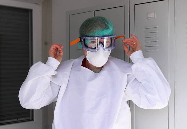 Tuebingen 24 03 2020 Corona Container Ambulance Tuebingen, Covid 19 Care at the Tuebingen fairground Dr Julia Martin putting on protective clothing for the outpatient care of patients ULMER
