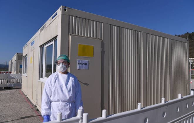 Tuebingen 24 03 2020 Corona Container Outpatient Clinic Tuebingen, Covid 19 Care at the Tuebingen fairground A medical student is waiting in front of a container for patients for outpatient care ULMER