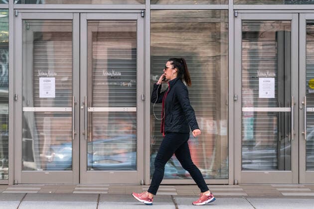 March 24, 2020, Washington, DC, UNITED STATES: A woman walks by a closed Neiman Marcus store in Washington, DC on Tuesday, March 24, 2020. Temporary store closures are all over the city to prevent the spread of the Corona Virus. To date the United States has 52,966 Corona Virus cases and 685 deaths. Stores President Donald Trump says he wants the nation opened up and just raring to go by Easter -- a date just more than two weeks away that few health experts believe will be sufficient in containing the spread of coronavirus. Washington UNITED STATES - ZUMAc206 20200324_zap_c206_013 Copyright: xKenxCedenox