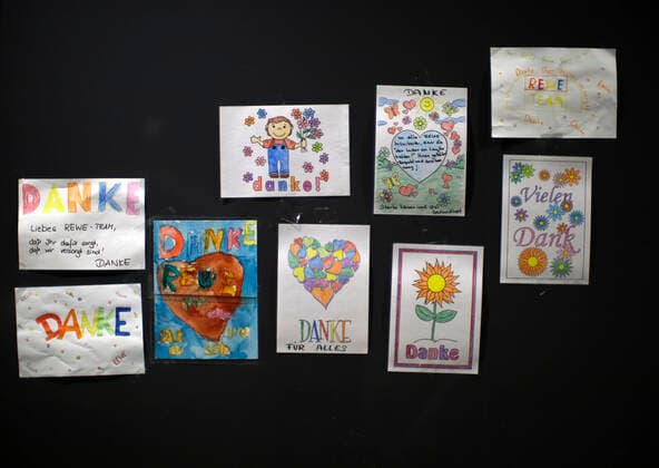 Düsseldorf, Germany, childrens drawings hanging in the entrance area of the REWE store Yade in Düsseldorf on 24 03 2020