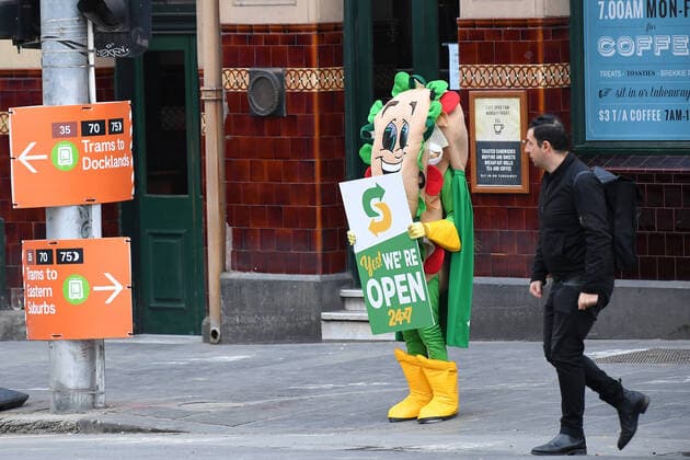 AUSTRALIA CORONAVIRUS COVID-19, A Subway employee dressed in a costume holds a sign advertising stores are still open is seen in Melbourne, Wednesday, March, 25, 2020. A shutdown of non-essential services is in effect Australia wide in a bid to slow the spread of the coronavirus (COVID-19) virus. ( NO ARCHIVING, EDITORIAL USE ONLY, NO USE IN BOOKS WITHOUT CONSENT MELBOURNE VICTORIA AUSTRALIA  Copyright: xJAMESxROSSx 20200325001459240468