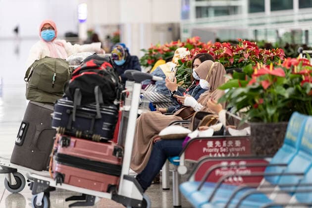 March 25, 2020, Hong Kong, China: Passengers wearing face masks as a precaution against the spread of Coronavirus wait for their delayed flight at the Hong Kong International airport..Temporally 14 days new measures in response to the latest situation of COVID-19 started on March 25, 2020, including compulsory quarantine for HK residents; Stop entry for non-Hong Kong residents from overseas and suspend all transit services along with limited service provided from the airport shops and restaurants. Hong Kong China - ZUMAs197 20200325_zaa_s197_004 Copyright: xMayxJamesx