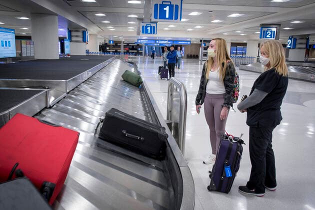 March 24, 2020, Phoenix, Arizona, U.S: Kathy Argenta, right, meets her daughter Kaitlin Leonard at a sparsely populated Sky Harbor International Airport in Phoenix, Arizona, March 24, 2020. Leonard was returning home from a university in Missouri after the rest of the semester was moved to online instruction due to the Covid-19 Corona virus. Phoenix U.S. - ZUMAd90_ 20200324_zap_d90_023 Copyright: xRickxD™Eliax