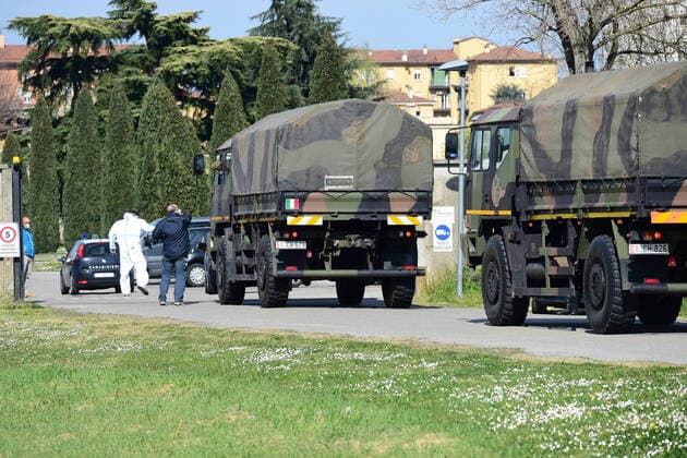 (200324) -- BOLOGNA (ITALY), March 24, 2020 (Xinhua) -- Military trucks carry bodies of patients who died from COVID-19 infections from Bergamo to Bologna, Italy, on March 24, 2020. The COVID-19 pandemic has claimed 6,820 lives in locked-down Italy by Tuesday with the cumulative number of cases reaching 69,176, according to new data released by the Civil Protection Department. (Photo by Gianni Schicchi Xinhua) ITALY-BOLOGNA-COVID-19-DEATH 