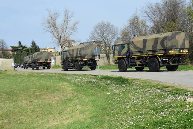 (200324) -- BOLOGNA (ITALY), March 24, 2020 (Xinhua) -- Military trucks carry bodies of patients who died from COVID-19 infections from Bergamo to Bologna, Italy, on March 24, 2020. The COVID-19 pandemic has claimed 6,820 lives in locked-down Italy by Tuesday with the cumulative number of cases reaching 69,176, according to new data released by the Civil Protection Department. (Photo by Gianni Schicchi Xinhua) ITALY-BOLOGNA-COVID-19-DEATH 
