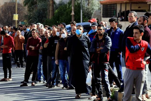 (200324) -- AMMAN, March 24, 2020 -- People stand in line to buy bread in Amman, Jordan, on March 24, 2020. Jordan on Tuesday started allowing the distribution of bread, bottled water and medicine across the country, an official said on Tuesday. The number of COVID-19 cases reached 153 in the country on Tuesday. (Photo by Xinhua) JORDAN-AMMAN-COVID-19 MohammadxAbuxGhosh 