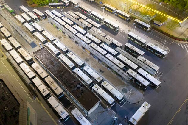 (200325) -- WUHAN, March 25, 2020 -- Aerial photo taken on March 25, 2020 shows buses waiting at the terminus at Hankou Railway Station in Wuhan, central China s Hubei Province. Wuhan, the once hardest-hit city in central China s Hubei Province during the COVID-19 outbreak, resumed a total of 117 bus routes starting Wednesday, around 30 percent of the city s total bus transport capacity, the municipal transport bureau said. According to a spokesperson of the bureau, passengers must wear masks, register with their names and scan a QR code, and take a temperature check before taking buses and subways. ) CHINA-HUBEI-WUHAN-COVID-19-BUS ROUTES-RESUMPTION (CN) CaixYang