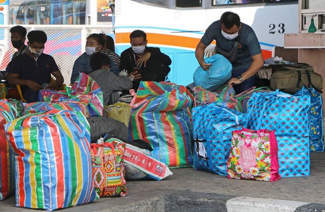 March 25, 2020, Bangkok, Thailand: Migrant workers sit as thye wait to leave from city at Bus Terminal in Bangkok on March 25, 2020. The government will declare an emergency and introduce new measures to combat the coronavirus disease 2019 (Covid-19) on Thursday26 March 2020, Prime Minister Prayut Chan-o-cha said. Bangkok Thailand - ZUMAu103 20200325_zia_u103_007 Copyright: xUrdeexImagex