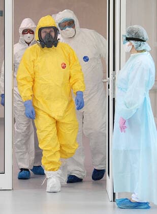 MOSCOW, RUSSIA - MARCH 24, 2020: Russia s President Vladimir Putin wears a yellow protective suit on his visit to the Novomoskovsky multipurpose medical center for patients suspected of the COVID-19 coronavirus infection. Alexei Druzhinin Russian Presidential Press and Information Office TASS  TS0D3411