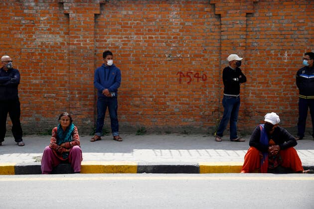 March 25, 2020, Kathmandu, Nepal: People wait along the empty streets in hope to get their cooking gas cylinders refilled on the second day of the week long nationwide lockdown in an effort to control the spread of COVID-19 in Lalitpur, Nepal on Wednesday, March 25, 2020. Kathmandu Nepal - ZUMAg200 20200325_zap_g200_008 Copyright: xSkandaxGautamx