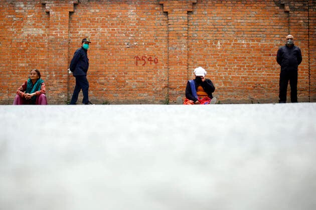 March 25, 2020, Kathmandu, Nepal: People wait along the empty streets in hope to get their cooking gas cylinders refilled on the second day of the week long nationwide lockdown in an effort to control the spread of COVID-19 in Lalitpur, Nepal on Wednesday, March 25, 2020. Kathmandu Nepal - ZUMAg200 20200325_zap_g200_011 Copyright: xSkandaxGautamx
