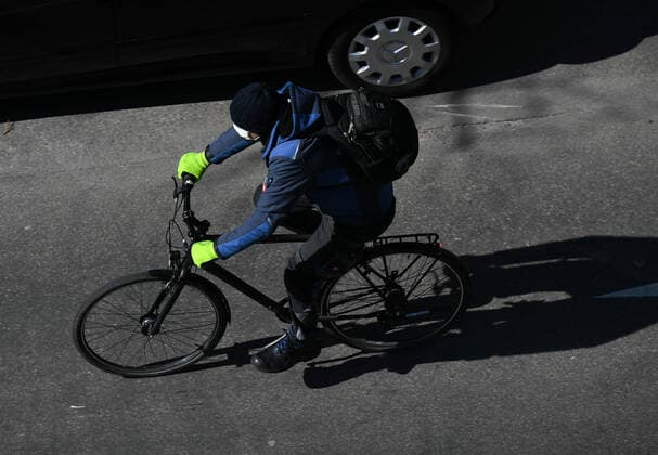 (200325) -- FRANKFURT, March 25, 2020 -- A man with a facial mask rides a bicycle on a street in Frankfurt, Germany, March 24, 2020. Germany s confirmed cases of COVID-19, the disease caused by the novel coronavirus increased by 4,764 within one day to 27,436 on Tuesday, the Robert Koch Institute (RKI) announced Tuesday. So far, Germany has recorded 114 deaths as of Tuesday, according to RKI, the federal government agency and research institute responsible for disease control and prevention. ) GERMANY-FRANKFURT-COVID-19 LuxYang