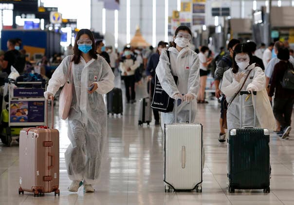 March 25, 2020, Bangkok, Thailand: Foreign tourists wear suits to protect Coronavirus Covid-19 during check-in at Suvarnabhumi International airport in Bangkok on March 25, 2020. The government will declare an emergency and introduce new measures to combat the coronavirus disease 2019 (Covid-19) on Thursday26 March 2020, Thai Prime Minister Prayut Chan-o-cha said. Bangkok Thailand - ZUMAu103 20200325_zia_u103_014 Copyright: xUrdeexImagex