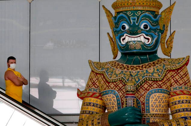March 25, 2020, Bangkok, Thailand: Foreign tourist walks past a giant statue while check-in at Suvarnabhumi International airport in Bangkok on March 25, 2020. The government will declare an emergency and introduce new measures to combat the coronavirus disease 2019 (Covid-19) on Thursday26 March 2020, Prime Minister Prayut Chan-o-cha said. Bangkok Thailand - ZUMAu103 20200325_zia_u103_017 Copyright: xUrdeexImagex
