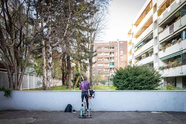 Milan - life in apartment buildings at the time of the Coronavirus. A man does bicycle training in the courtyard of his building in via Taormina, viale Marche area Editorial Usage Only  Copyright: xMarcoxPassarox xIPAx