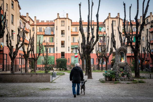 Milan - life in apartment buildings at the time of the Coronavirus. A man with the dog in the courtyard of a house in via Abbiati, San Siro Editorial Usage Only  Copyright: xMarcoxPassarox xIPAx