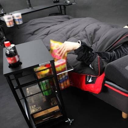 March 25, 2020: A Japanese furniture company have created the perfect coronavirus lockdown set-up with a gaming bed that has room for food and drinks...Video game addicts can now play, eat, drink and nap all without ever leaving their bed...The Ã‚Â£450 gaming bed by Bauhutte means gamers can play non-stop without having to leave for interruptions like eating or sleeping - only the call of nature might lure them away as the bed does not currently feature a bathroom... I wake up and move from my bed to my desk. Why is that so complicated? gaming furniture outfit Bauhutte says in promotions for the bed on its website... Gaming beds solve this problem. ..The bed comes with a desk that can support video screens, an elevating headboard and a headphone hanger...A metallic arm attached to the bed can mount a tablet screen above a person s fa - ZUMAc218 20200325_zia_c218_014 Copyright: xCOVERxImagesx