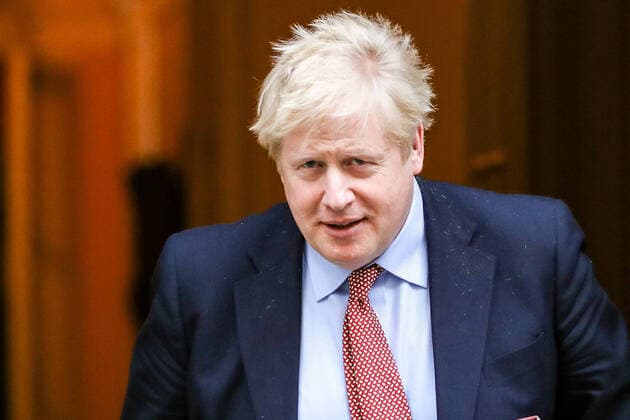 Britain s Prime Minister Boris Johnson waves to the media as he leaves 10 Downing Street for the House of Commons for his weekly Prime Ministers Questions, Wednesday, March 25, 2020. British lawmakers will vote later Wednesday to shut down Parliament for 4 weeks, due to the coronavirus outbreak. (Photo Vudi Xhymshiti)  iMagoVX