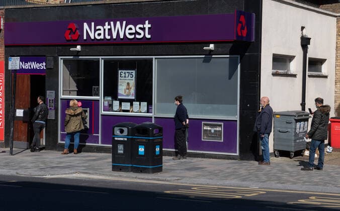 Customers outside National Westminster bank in Sidcup, Kent during the Coronavirus (COVID-19) outbreak where travel has been restricted across the country at Sidcup, England on 25 March 2020. Copyright: xAlanxStanfordx PMI-3450-0016