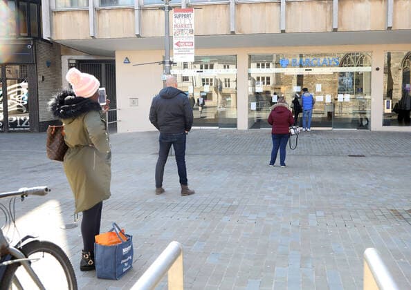 Day Two of Lockdown in Peterborough. People maintain personal distancing whilst queueing outside the Barclays bank in Peterborough. The country is on lockdown due to the COVID-19 Coronavirus pandemic. People are not allowed to leave home except for minimal food shopping, medical treatment, exercise - once a day, and essential work. COVID-19 Coronavirus lockdown, Peterborough, Cambridgeshire, UK, on March 25, 2020 