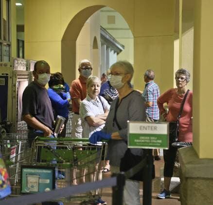 March 25, 2020, St. Petersburg, Florida, USA: Customers wait in line before the opening of the Publix store in the Northeast Park Shopping Center, St. Petersburg, Wednesday, March 25, 2020 at 7am. Publix designated Tuesday and Wednesday mornings, 7-8am as senior shopping hours for customers age 65 and over. St. Petersburg USA - ZUMAs70_ 20200325_zan_s70_001 Copyright: xScottxKeelerx