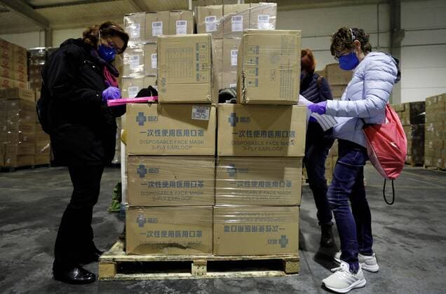 Workers sort out all the personal protective equipment (PPE) received from China at a warehouse in Valencia, Spain, 25 March 2020. A total of 3,800,000 masks, 5,000 protective suits and 2,000,000 gloves arrived to Valencia region to equip hospitals and elder homes in the need of this material amid the coronavirus outbreak. Spain is on its 11th consecutive day of national lockdown imposed by the government in an attempt to slow down the spread of the pandemic COVID-19 disease caused by the SARS-CoV-2 coronavirus. Protection material arrives to Spain from China !ACHTUNG: NUR REDAKTIONELLE NUTZUNG!  Copyright: xJuanxCarlosxCárdenasx GRAFCVA3413 20200325-637207248973602720