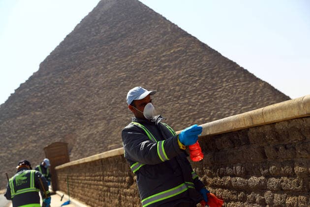 (200325) -- GIZA, March 25, 2020 (Xinhua) -- A staff member disinfects near the Pyramids in Giza, Egypt, March 25, 2020. Egypt announced on Tuesday that one COVID-19 case died and 36 new cases were detected, bringing the total number of cases in the country to 402. (Xinhua Ahmed Gomaa) EGYPT-GIZA-PYRAMIDS-DISINFECTION 