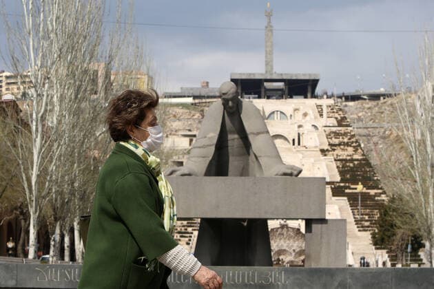 YEREVAN, ARMENIA - MARCH 25, 2020: A woman in a face mask walks past a monument to Alexander Tamanian near the Cascade during the pandemic of the novel coronavirus (COVID-19). As of 25 March 2020, Armenia has confirmed more than 250 cases of the novel coronavirus. The Armenian government declared a state of emergency and enforced restricted movement in connection with the pandemic on 16 March. Vahram Baghdasaryan Photolure TASS  TS0D354E