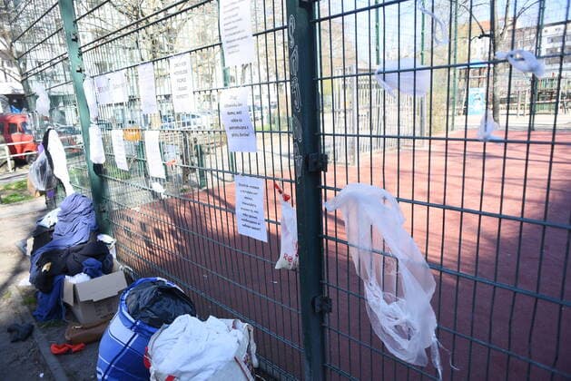 Some of the donation bags for homeless people hanging on this fence at Reuterplatz in Neukölln have already been emptied