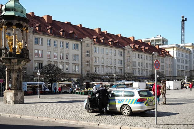 Police stands at the weekly market on the Old Market in Magdeburg and monitors the market activity in times of the Corona crisis