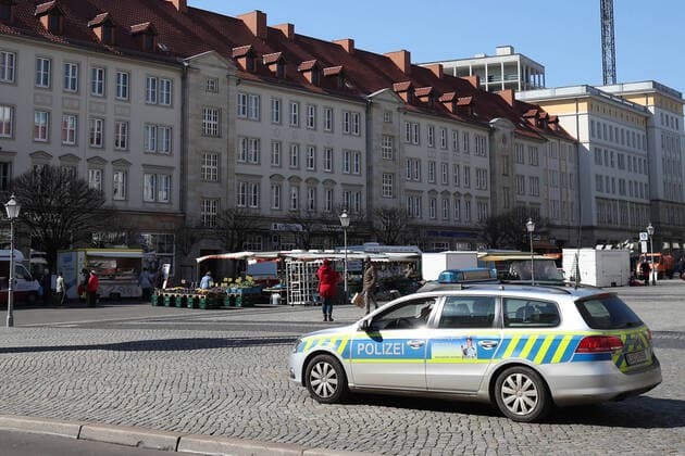 Police stands at the weekly market on the Old Market in Magdeburg and monitors the market activity in times of the Corona crisis