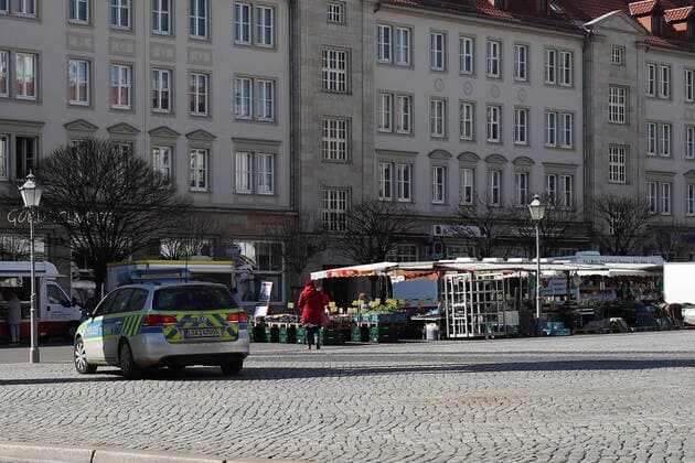 Police stands at the weekly market on the Old Market in Magdeburg and monitors the market activity in times of the Corona crisis