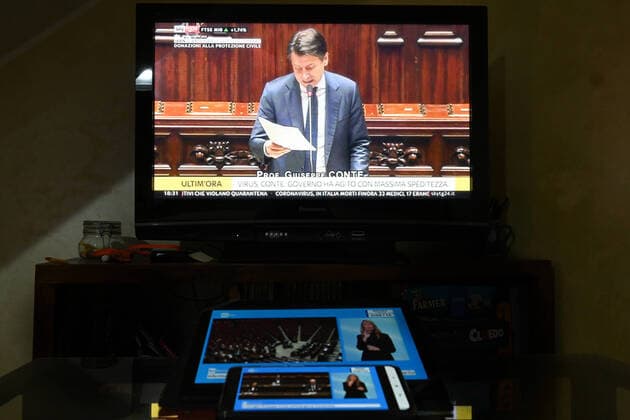 The italian Prime Minister Giuseppe Conte is seen on television, tablet and mobile phone, during his speech at the the lower chamber about the measures taken to counter the spread of the Coronavirus in Italy . Roma 25 03 2020 Photo Andrea Staccioli Insidefoto andreaxstaccioli