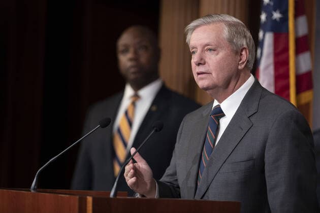 Senator Tim Scott (R-SC) listens to Senator Lindsey Graham (R-SC) speak during a press conference on amendments on Coronavirus Stimulus Package that need changed on Capitol Hill in Washington, D.C. on Wednesday, March 25, 2020. Senate will vote on Wednesday on $2 trillion coronavirus bill after landmark agreement with White House.  WAP202003250132 TASOSxKATOPODIS